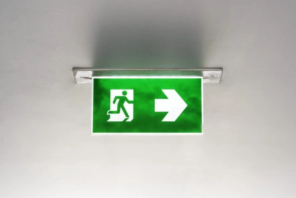 Green emergency exit sign on the ceiling Green emergency exit sign on the ceiling